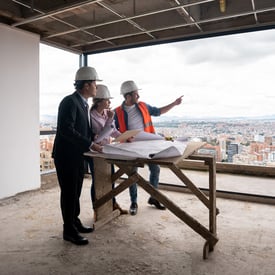 Low income housing developers meeting at a job site