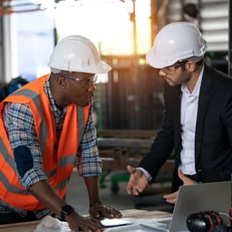 A bank lender and construction worker discussing commercial construction lending