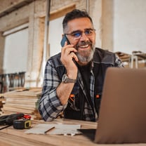 A commercial construction employee on the phone about commercial construction lending