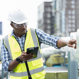 Construction employee looking at tablet