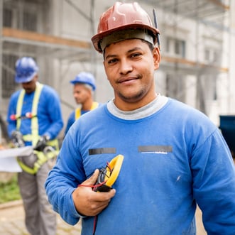 Small business owner standing in front of his construction job site 