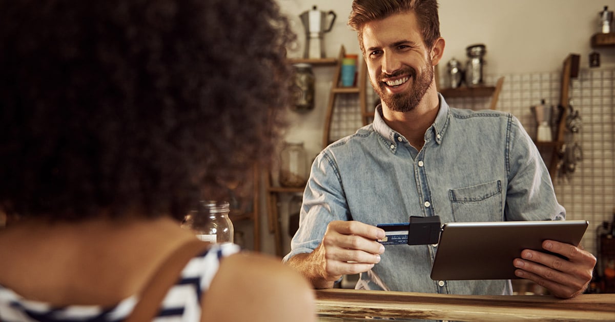 Employee swiping a customer's credit card 