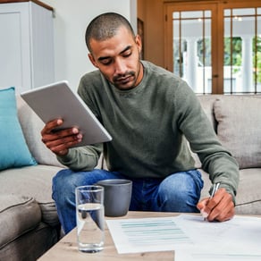 Man holding ipad, comparing account options