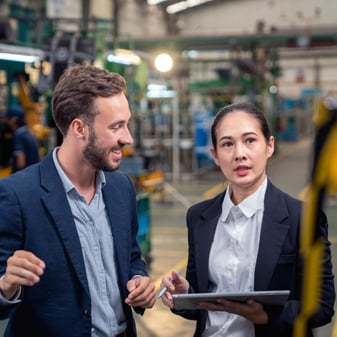 Small business owner and equipment finance lender in warehouse