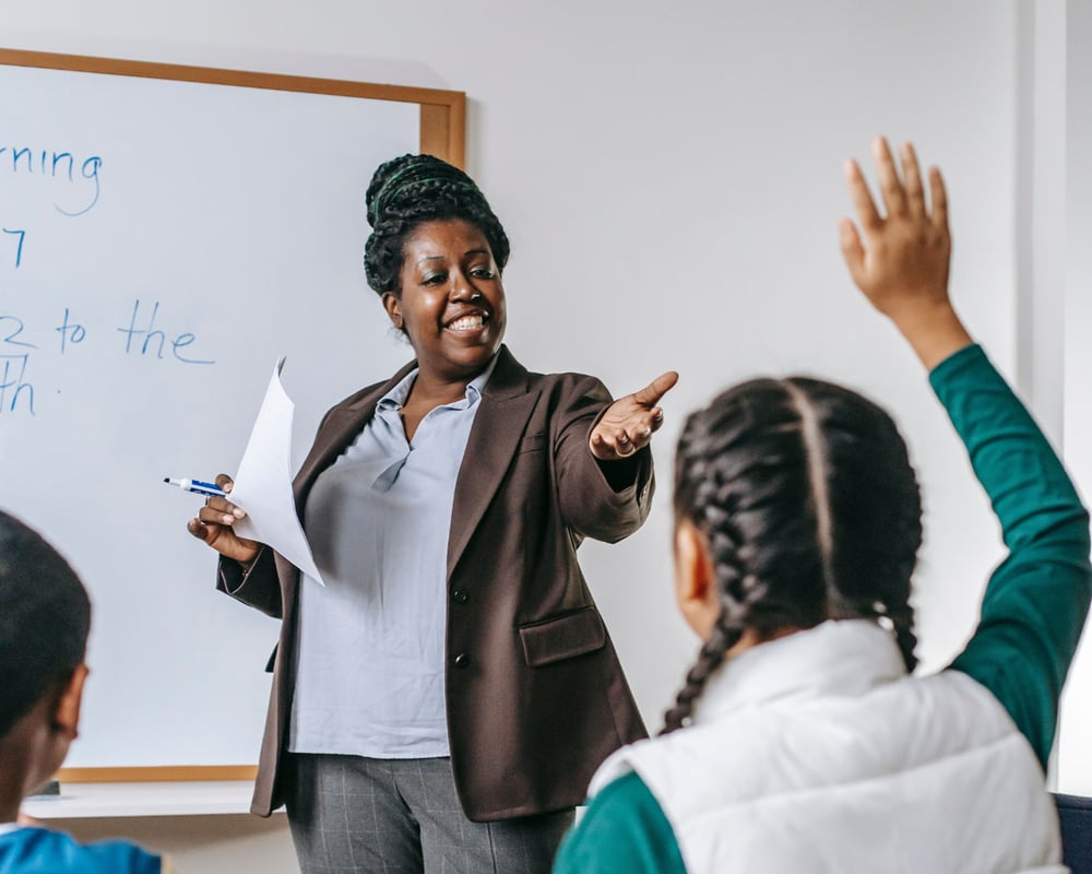 High school teacher calling on a student in class