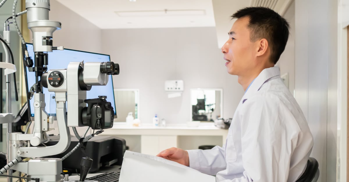 Optometrist small business owner sitting at desk