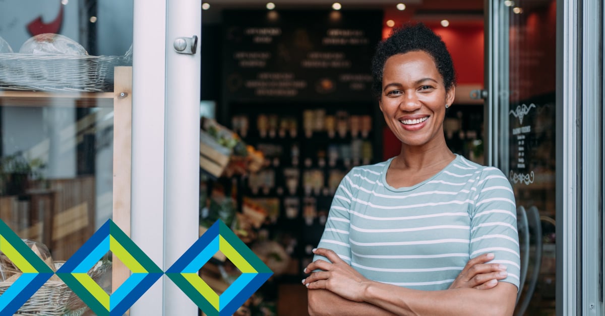 Small business owner standing in the doorway of her shop