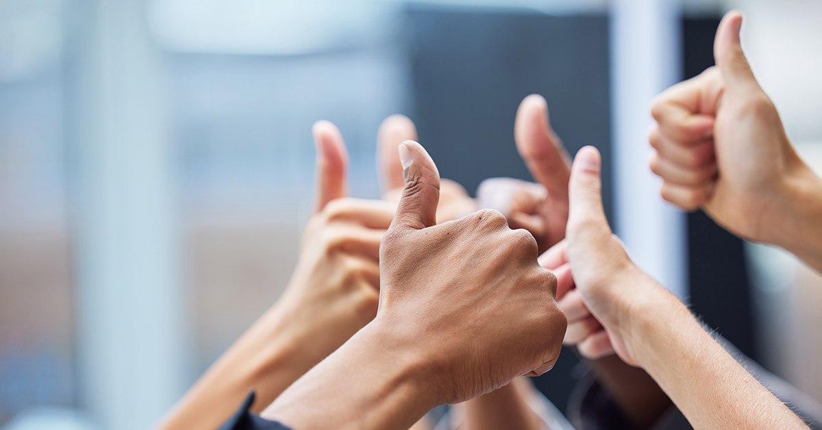 Various hands holding a thumbs up