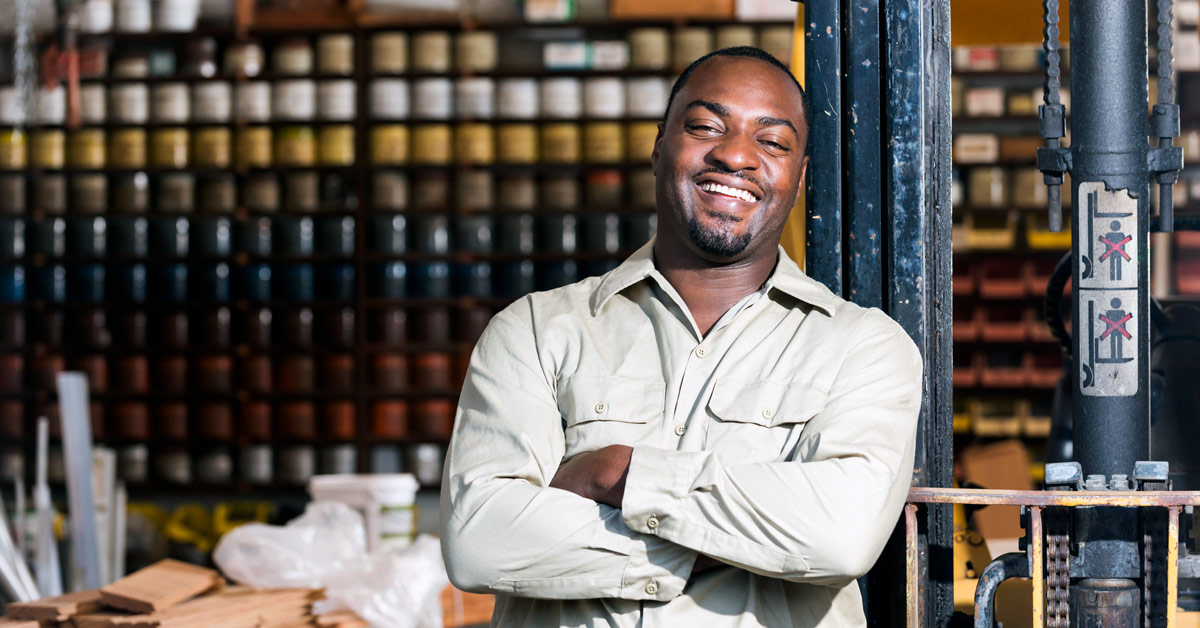 Small business owner standing in front of his place of business 