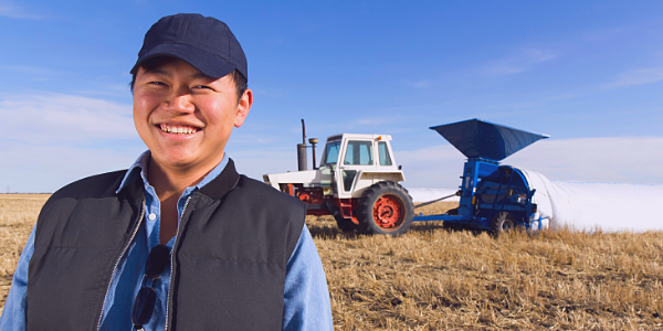 Farmer in front of tractor in field