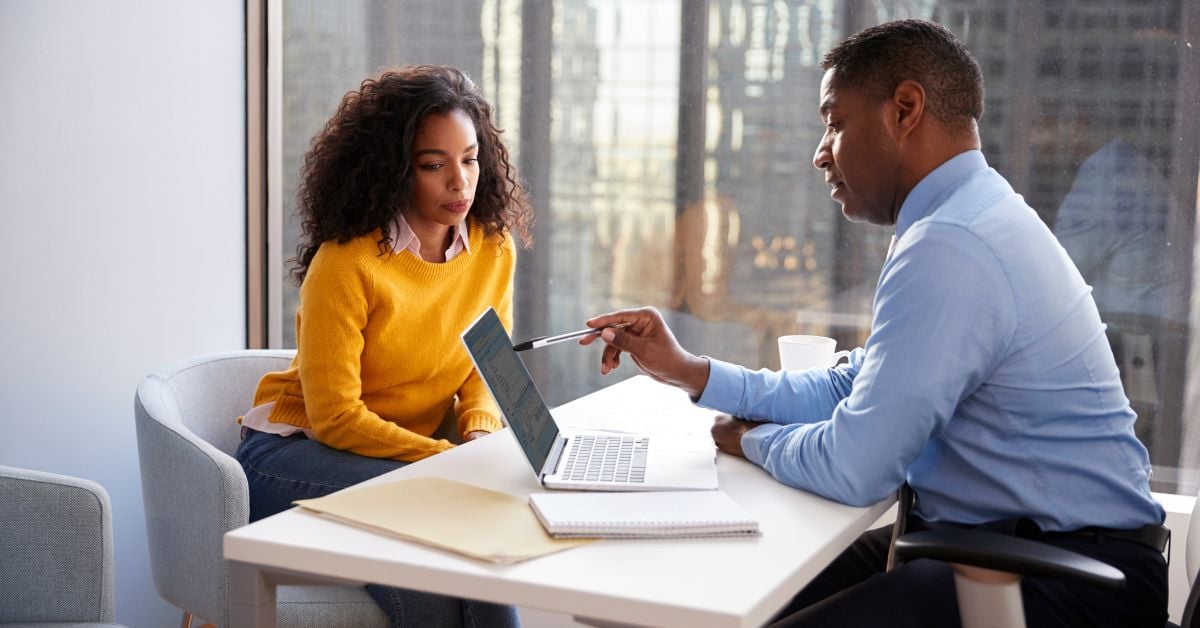 Business owner and Bank employee discussing FDIC insurance at a desk