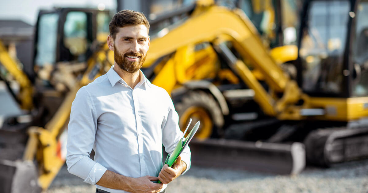 Small business owner standing in front of his equipment 