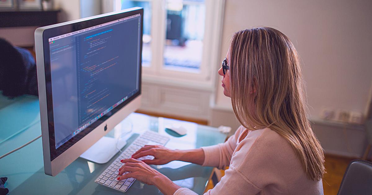 Woman on a computer examining data and systems